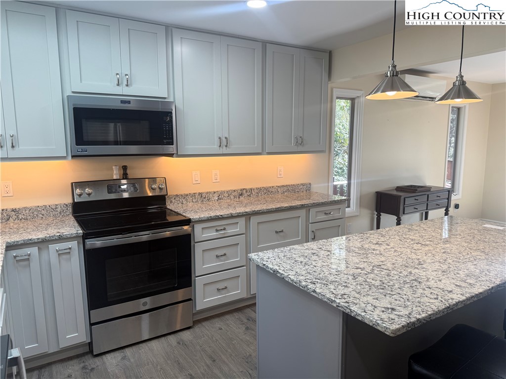 174 Spruce Pine Road Newland, NC 28657 - Photo 15 of 41 a kitchen with granite countertop a sink and a stove