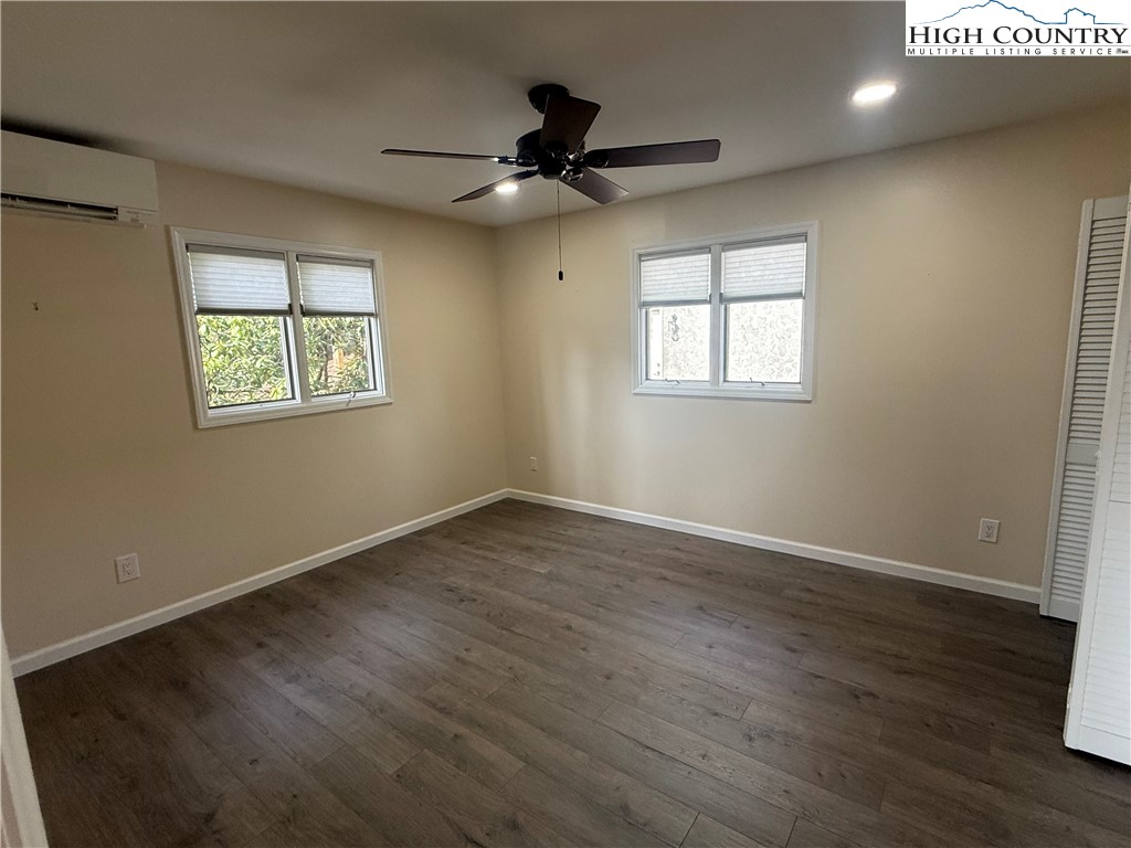 174 Spruce Pine Road Newland, NC 28657 - Photo 19 of 41 a view of an empty room with wooden floor and a window