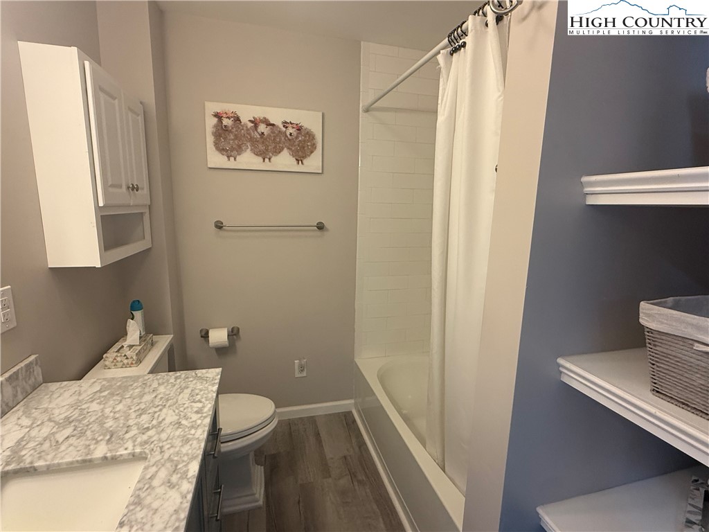 174 Spruce Pine Road Newland, NC 28657 - Photo 22 of 41 a bathroom with a granite countertop sink toilet and shower