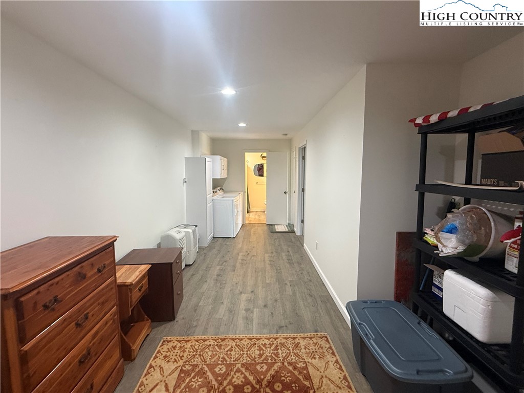 174 Spruce Pine Road Newland, NC 28657 - Photo 26 of 41 a hallway with front door wooden floor and windows