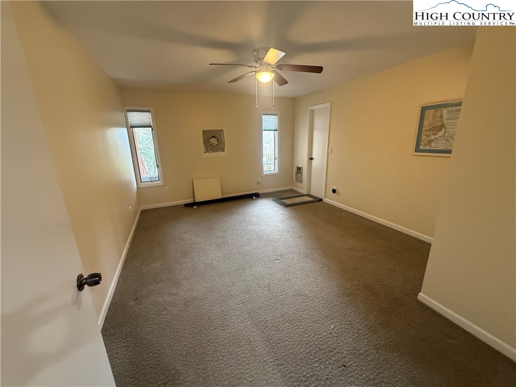 174 Spruce Pine Road Newland, NC 28657 - Photo 30 of 41 an empty room with windows and fan