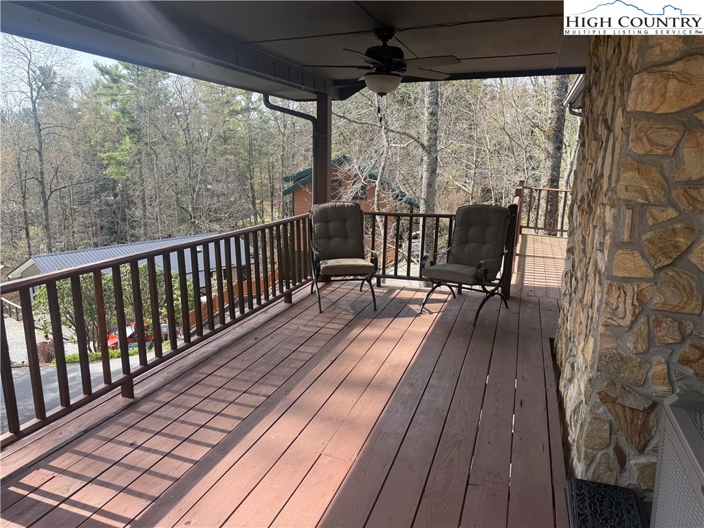 174 Spruce Pine Road Newland, NC 28657 - Photo 8 of 41 a view of a balcony with chairs and wooden floor