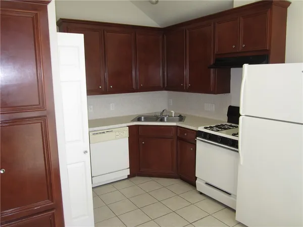 a kitchen with a refrigerator stove and cabinets
