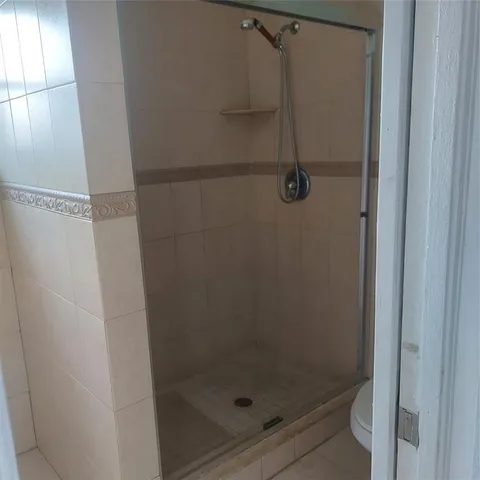 a bathroom with a glass shower door