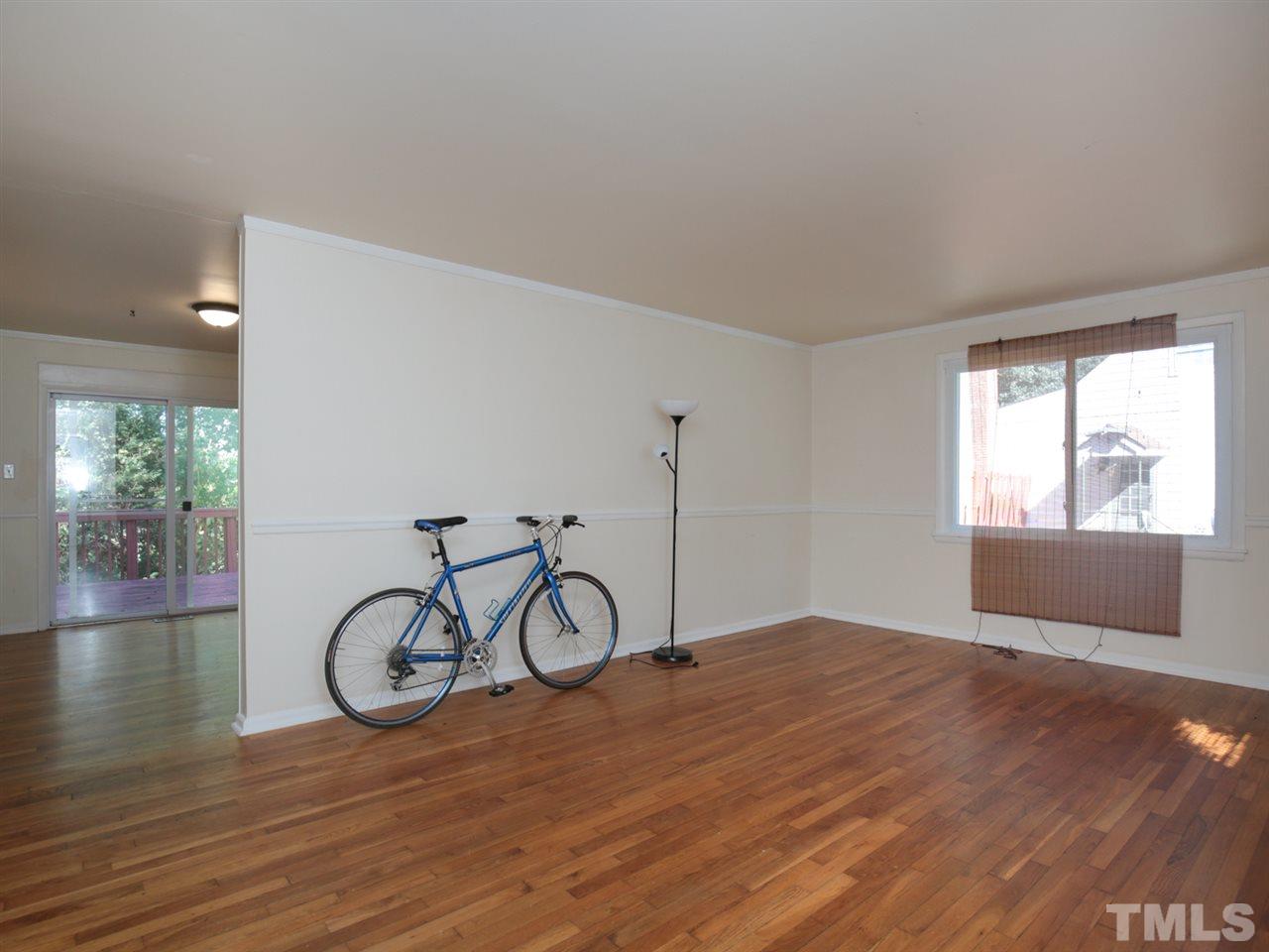 3421 Cheyenne Road Raleigh, NC 27609 - Photo 2 of 25 a view of a livingroom with wooden floor and a window