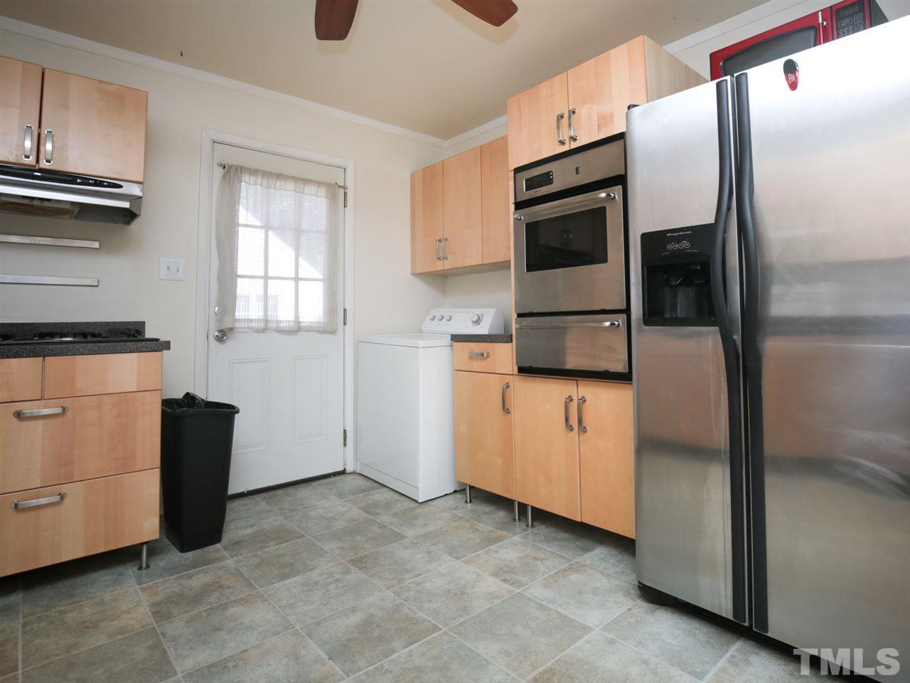 3421 Cheyenne Road Raleigh, NC 27609 - Photo 11 of 25 a kitchen with white cabinets and refrigerator