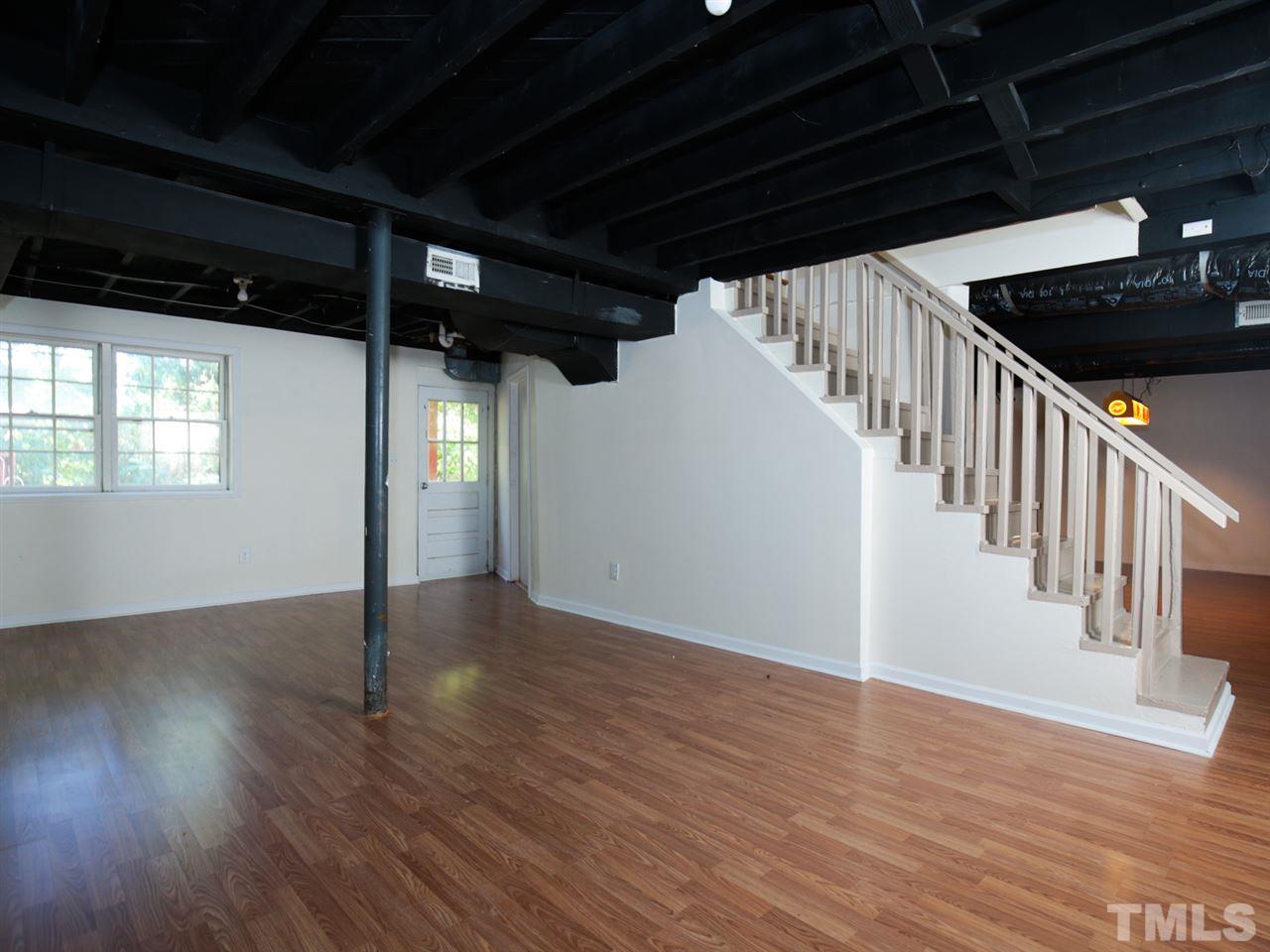 3421 Cheyenne Road Raleigh, NC 27609 - Photo 16 of 25 a view of an empty room with wooden floor and stairs