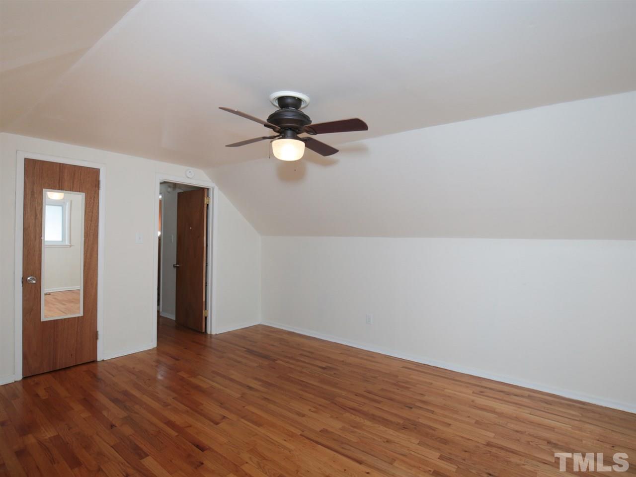 3421 Cheyenne Road Raleigh, NC 27609 - Photo 18 of 25 a view of a room with wooden floor and a ceiling fan