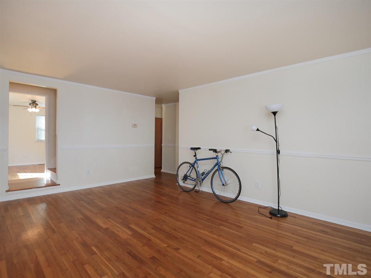 3421 Cheyenne Road Raleigh, NC 27609 - Photo 3 of 25 a view of a livingroom with wooden floor and white walls