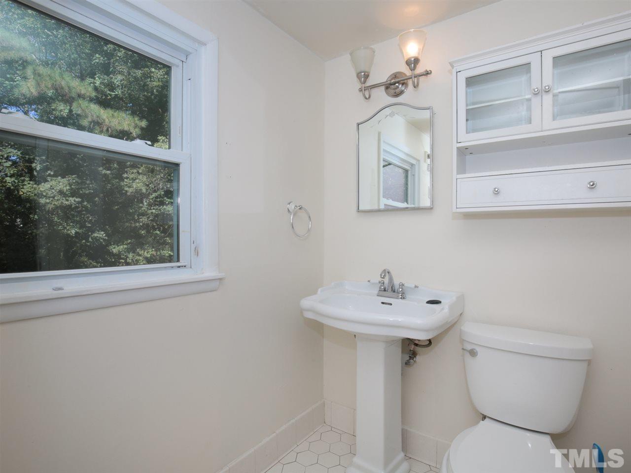 3421 Cheyenne Road Raleigh, NC 27609 - Photo 21 of 25 a bathroom with a sink mirror and toilet