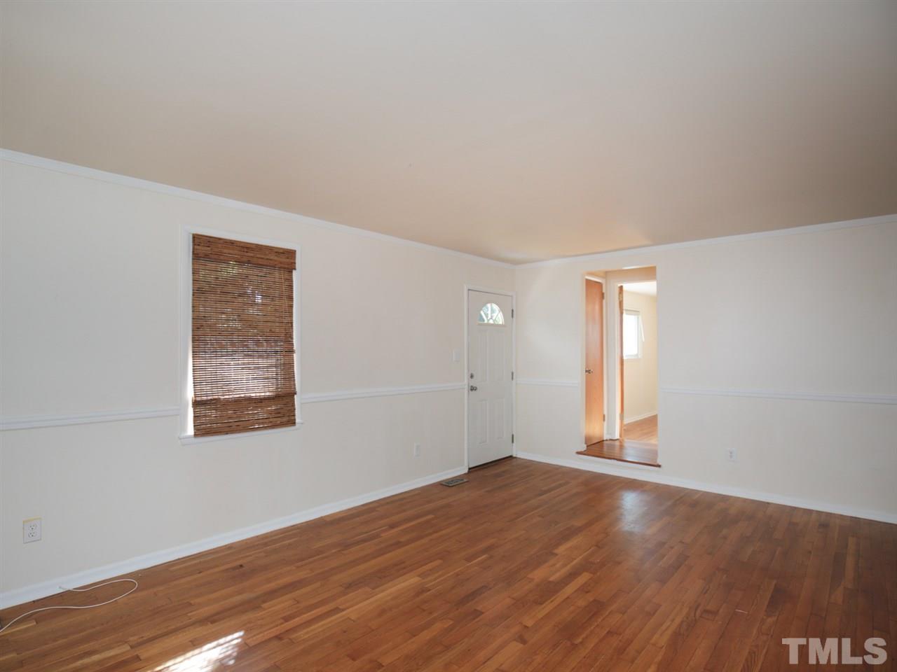 3421 Cheyenne Road Raleigh, NC 27609 - Photo 4 of 25 an empty room with wooden floor and windows