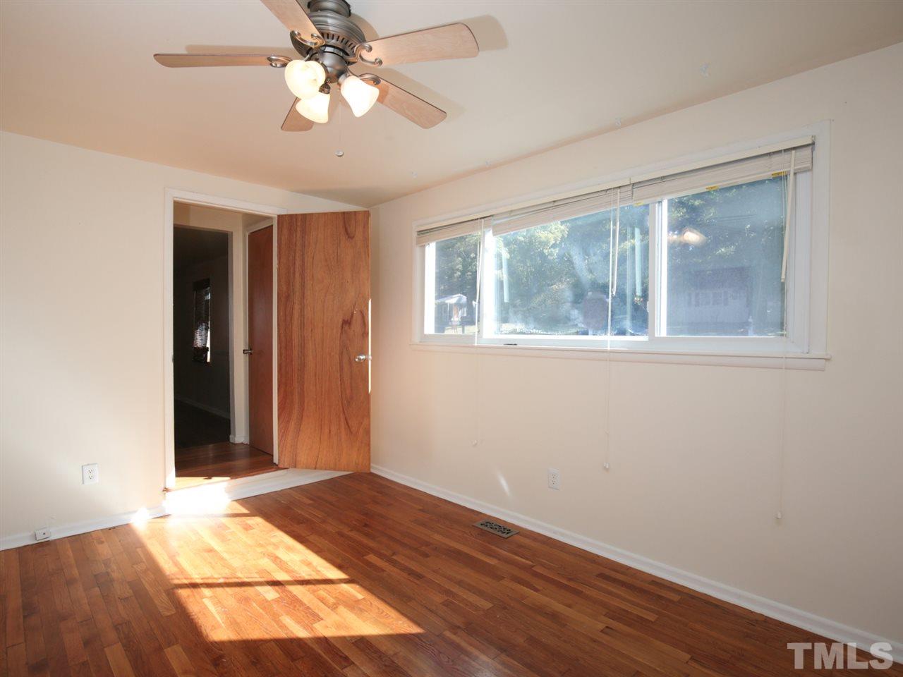3421 Cheyenne Road Raleigh, NC 27609 - Photo 6 of 25 wooden floor in an empty room with a window
