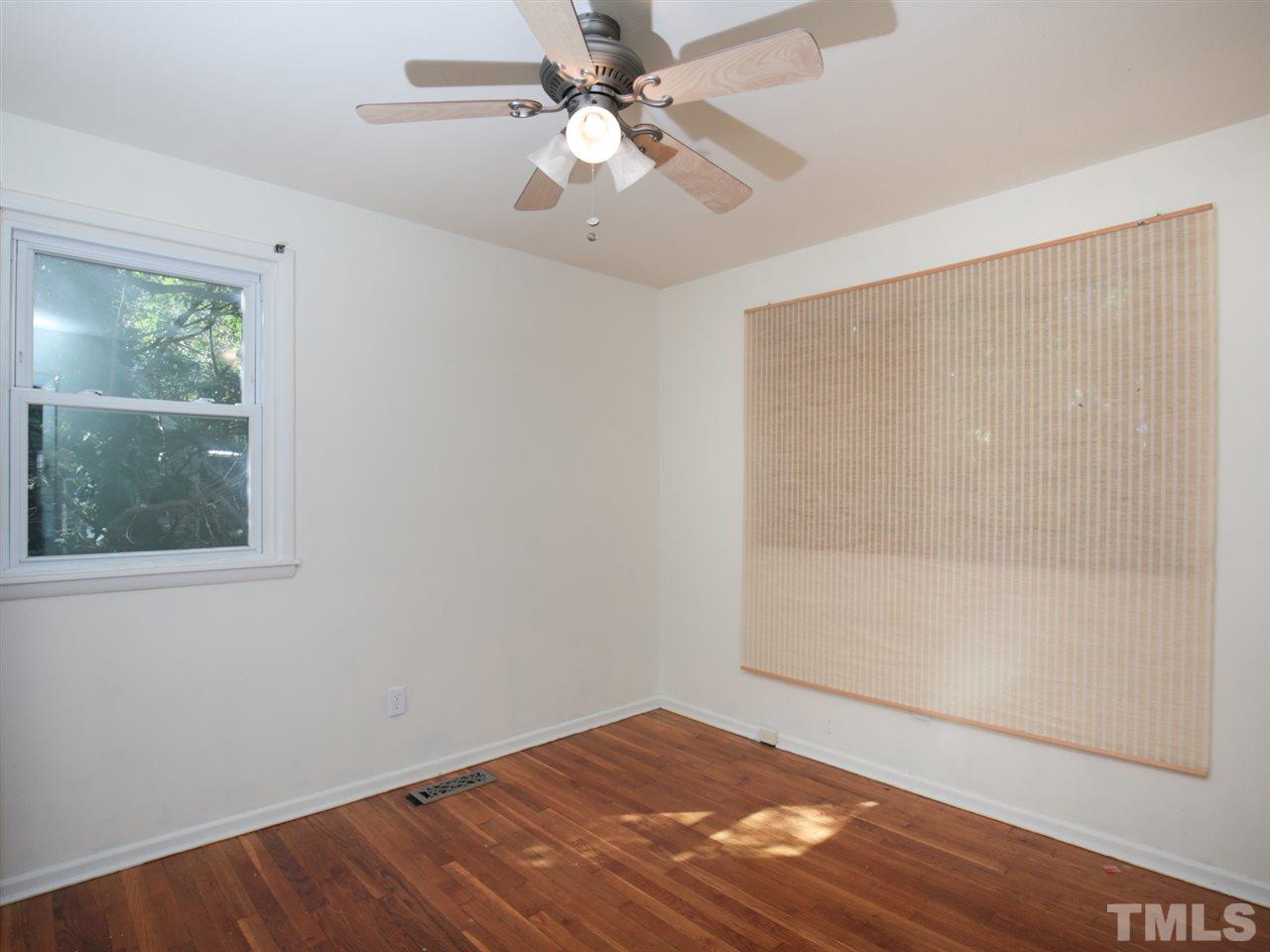 3421 Cheyenne Road Raleigh, NC 27609 - Photo 7 of 25 an empty room with a window and a ceiling fan