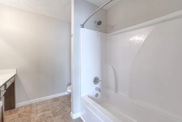 a bathroom with a bathtub and a shower