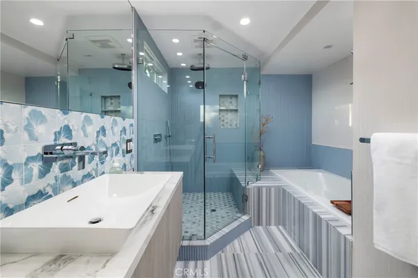 a bathroom with a bathtub and a shower