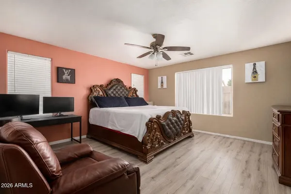 a spacious bedroom with a bed couch and a window