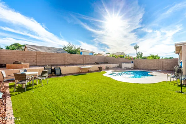 a view of a swimming pool with a table and chairs