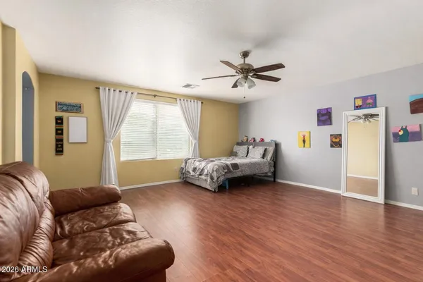 a bedroom with furniture and a large window