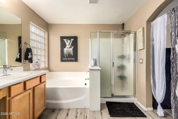 a bathroom with a sink a toilet a mirror and shower