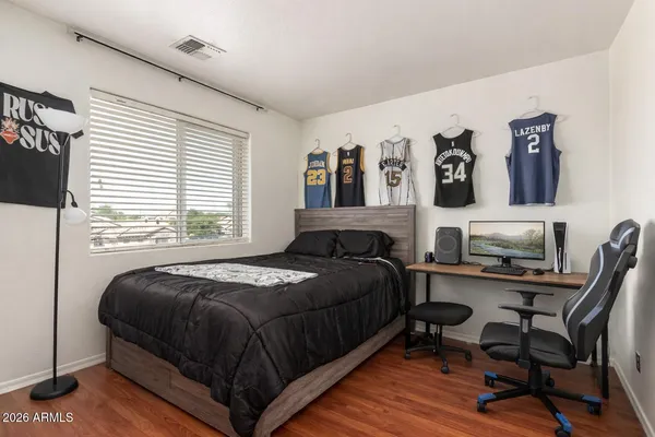 a bedroom with a bed and a desk