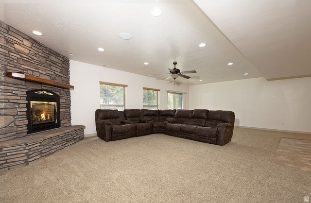 888 East Fiddlers Canyon Road Cedar City, UT 84721 - Photo 39 of 74 Living area with light colored carpet, a ceiling fan, a fireplace, and recessed lighting