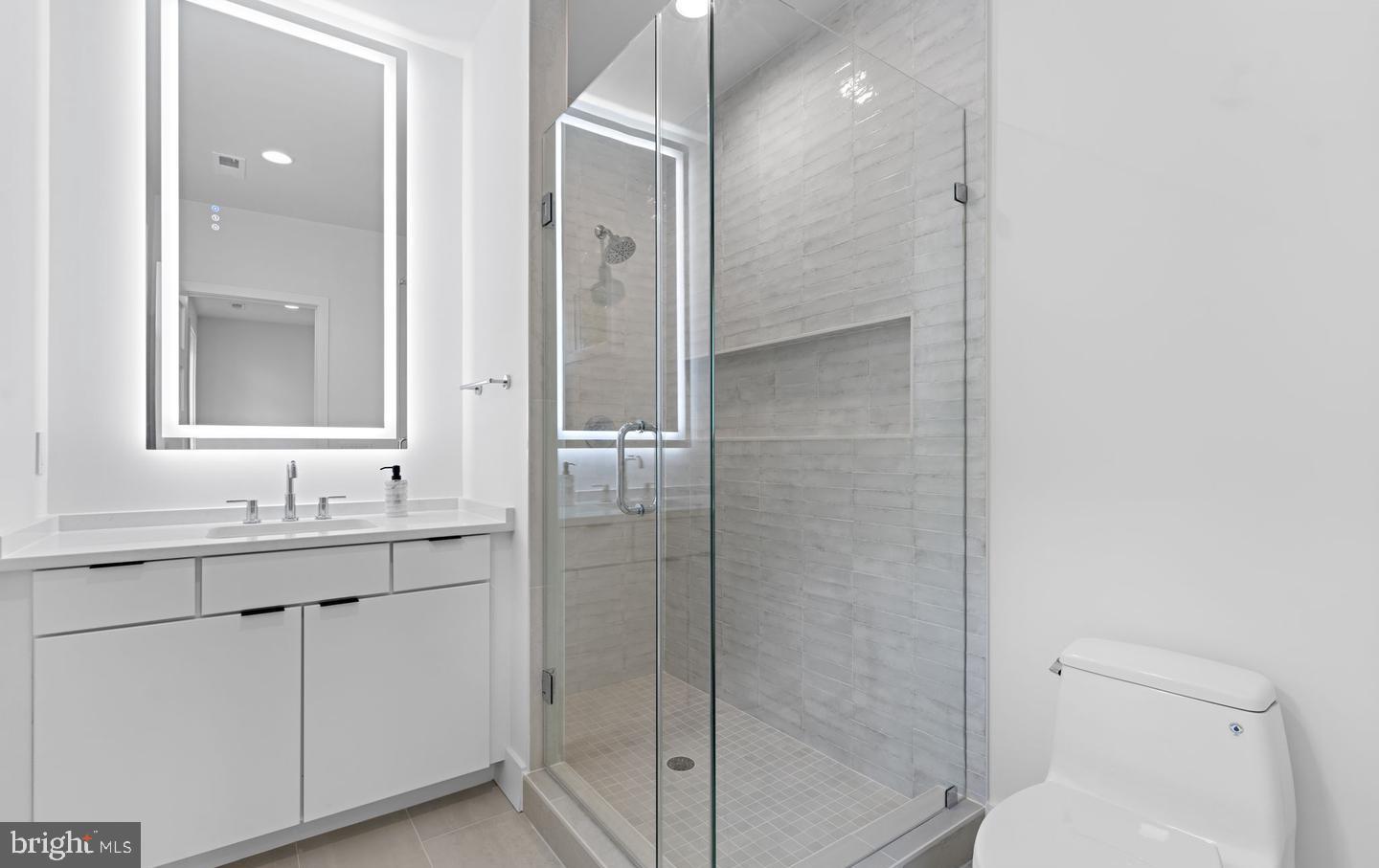 6330 Cross Street McLean, VA 22101 - Photo 12 of 19 a bathroom with a shower sink and mirror