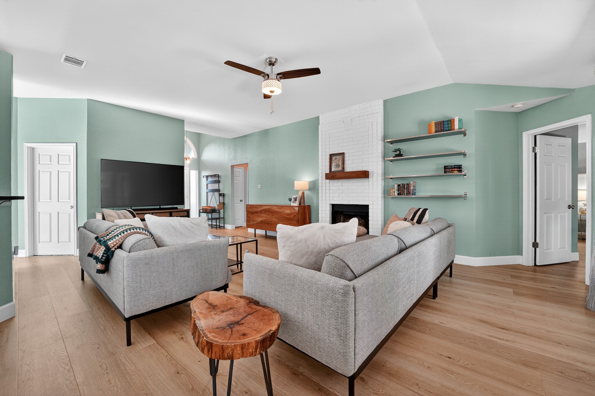1811 Old Mill Road Cedar Park, TX 78613 - Photo 7 of 39 Step into this luminous living space featuring a cozy fireplace, light hardwood flooring, and ample room for gatherings.