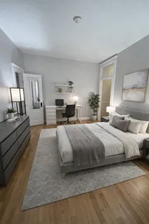a spacious bedroom with a large bed and a dresser