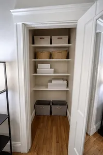 a view of walk in closet with empty racks