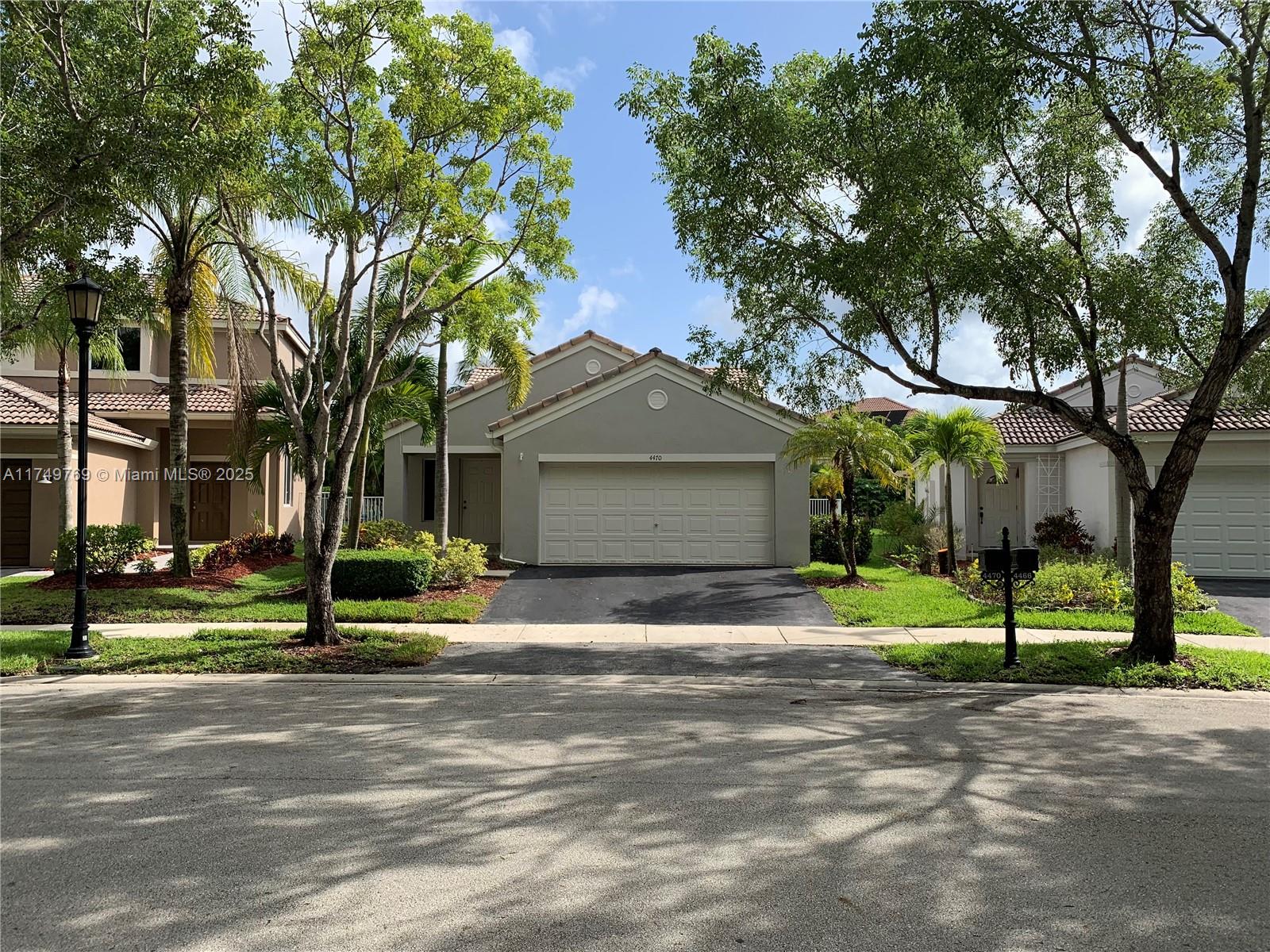 The Ridges Weston, FL 33331 - Photo 1 of 51 a front view of a house with a garden