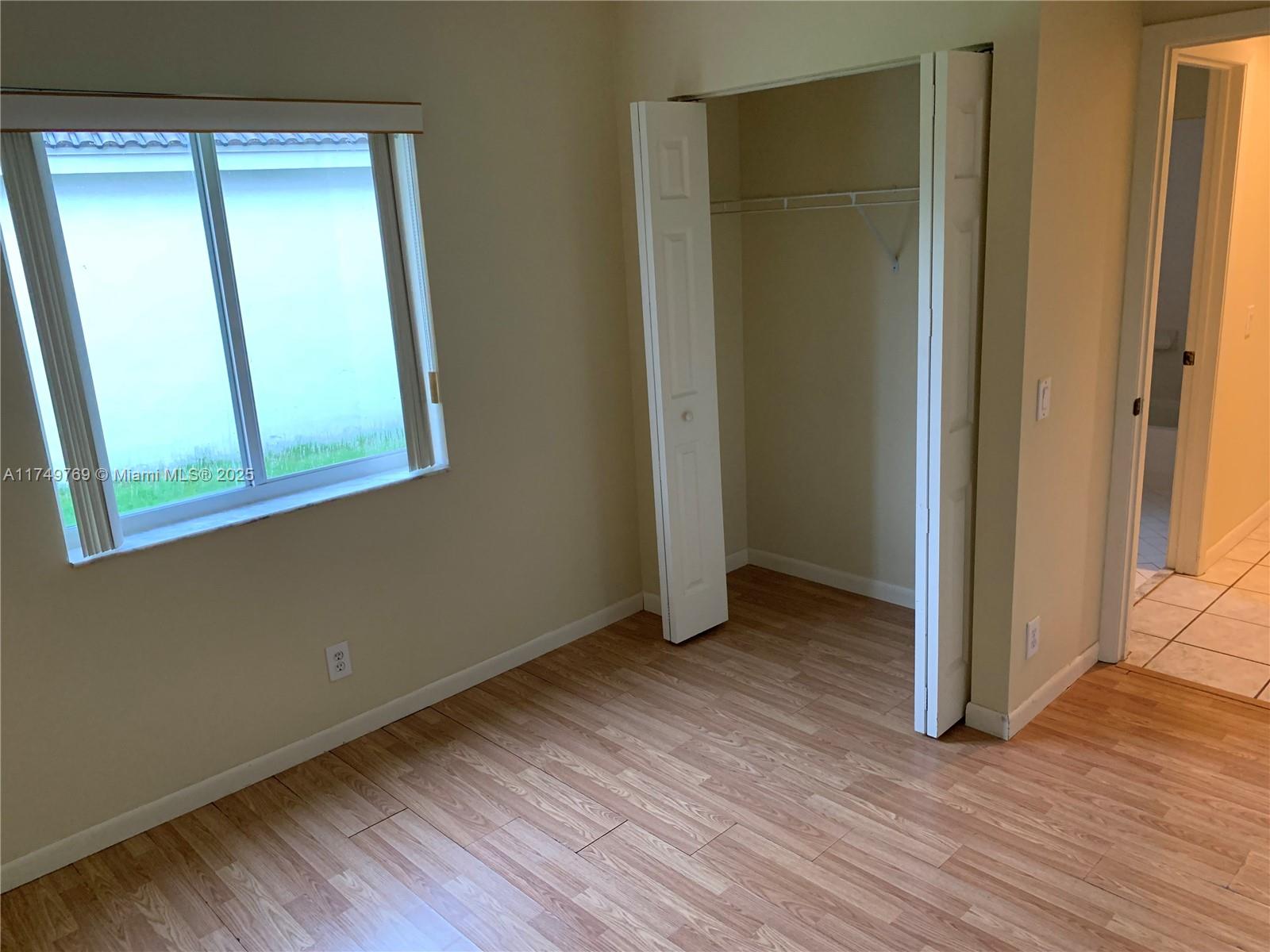 The Ridges Weston, FL 33331 - Photo 28 of 51 an empty room with wooden floor and a window