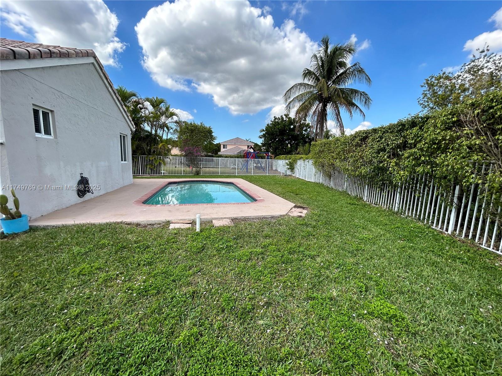 The Ridges Weston, FL 33331 - Photo 49 of 51 a view of swimming pool with a garden
