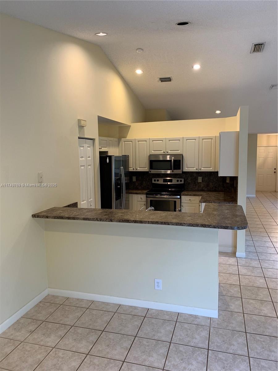 The Ridges Weston, FL 33331 - Photo 6 of 51 a view of cabinets and kitchen with stainless steel appliances