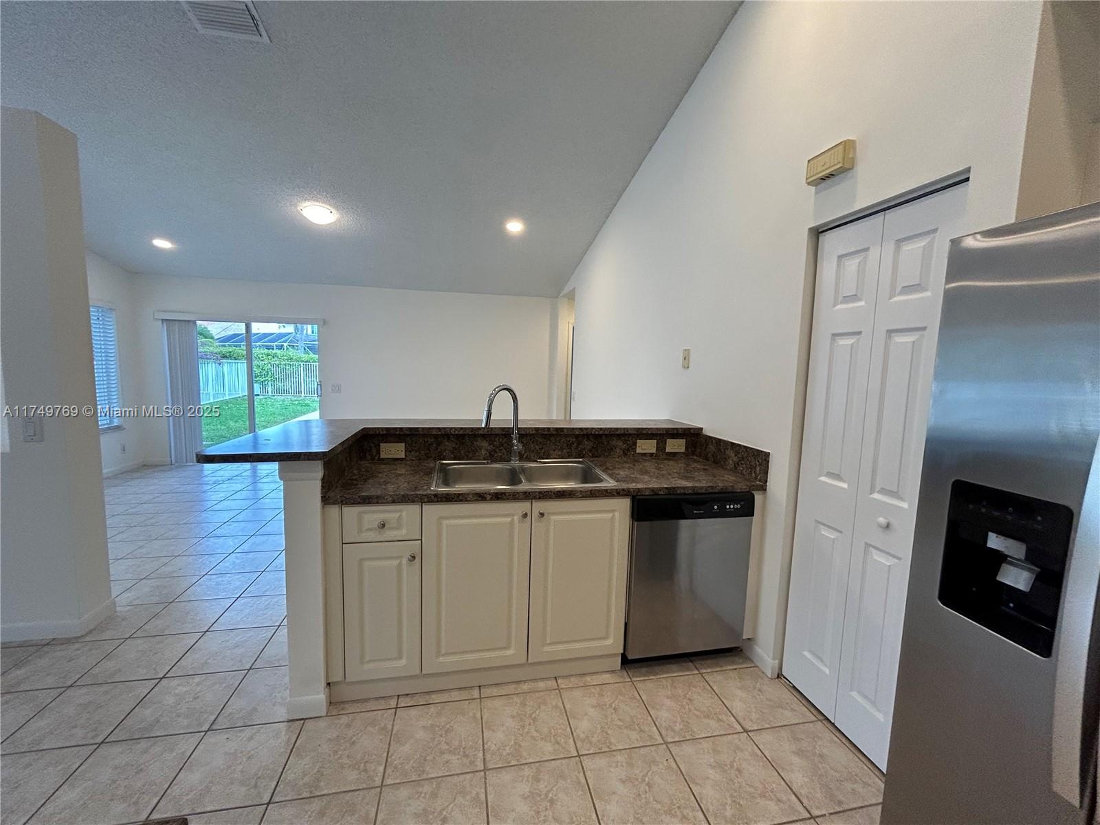 The Ridges Weston, FL 33331 - Photo 7 of 51 a kitchen with stainless steel appliances granite countertop a sink and a refrigerator