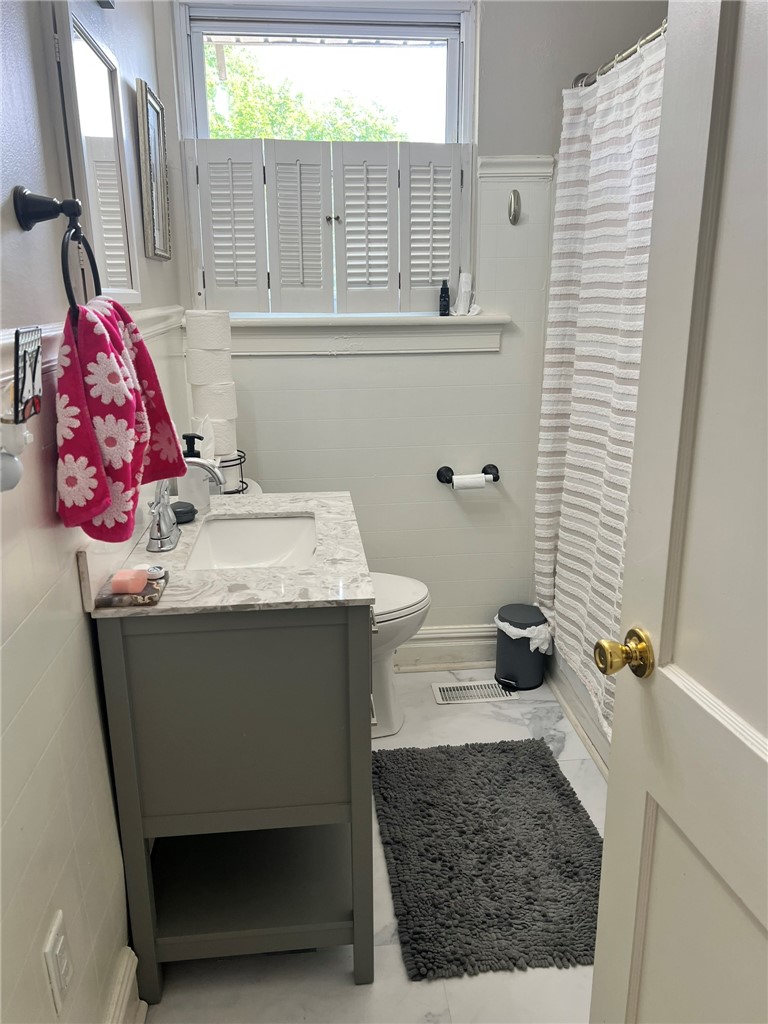 101 Clinton Drive, Unit B Anderson, SC 29621 - Photo 8 of 18 This bright bathroom features elegant marble flooring and a modern vanity, offering comfort and style.