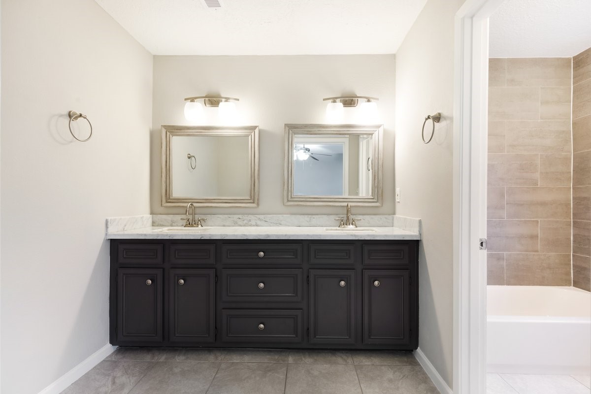 1403 Neptune Lane Houston, TX 77062 - Photo 11 of 20 a bathroom with a granite countertop sink mirror and bathtub