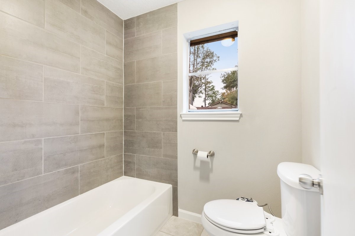 1403 Neptune Lane Houston, TX 77062 - Photo 12 of 20 a bathroom with a toilet and a bathtub