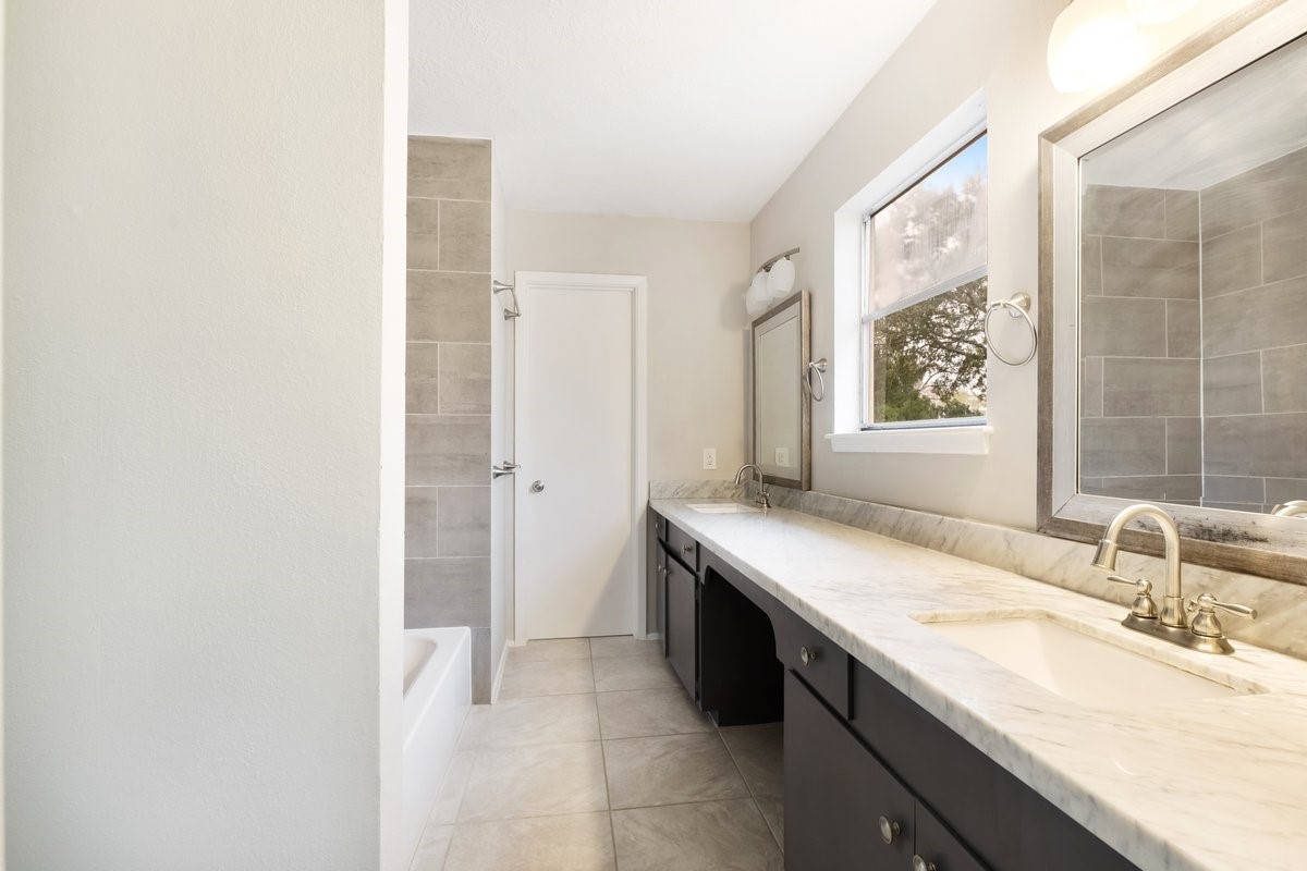 1403 Neptune Lane Houston, TX 77062 - Photo 16 of 20 a bathroom with a granite countertop sink and a mirror