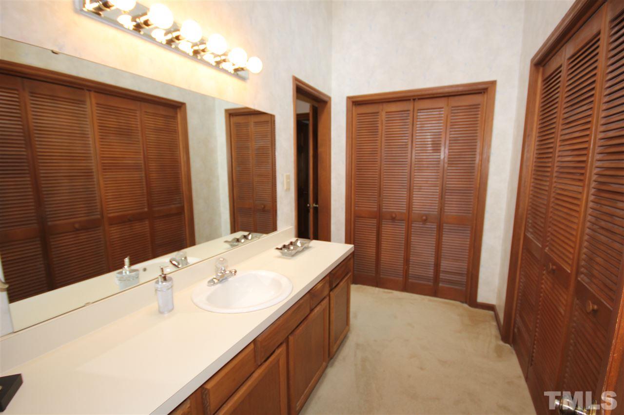 5305 Ridgeloch Place Raleigh, NC 27612 - Photo 17 of 23 a bathroom with a sink and a mirror