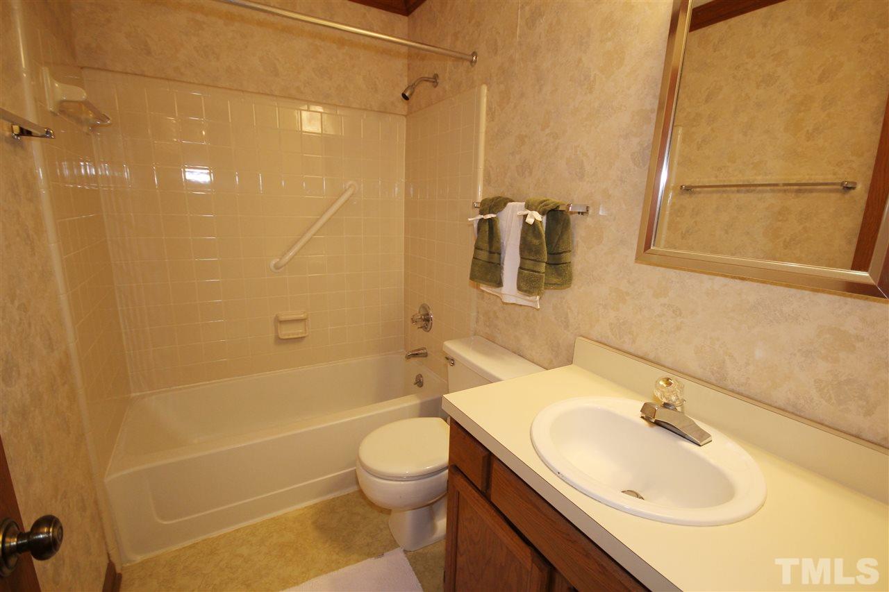 5305 Ridgeloch Place Raleigh, NC 27612 - Photo 20 of 23 a bathroom with a sink a toilet and shower