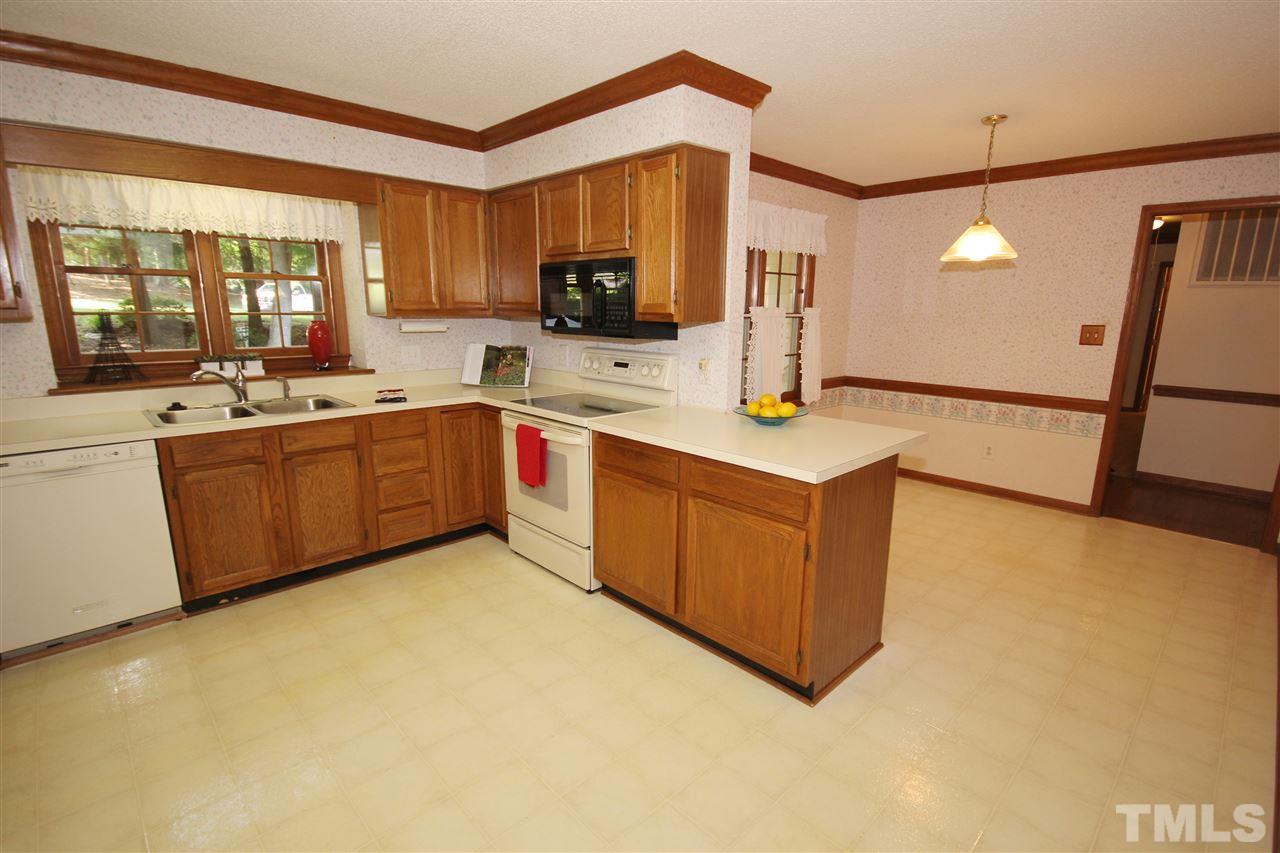 5305 Ridgeloch Place Raleigh, NC 27612 - Photo 6 of 23 a large kitchen with stainless steel appliances granite countertop a stove and a sink