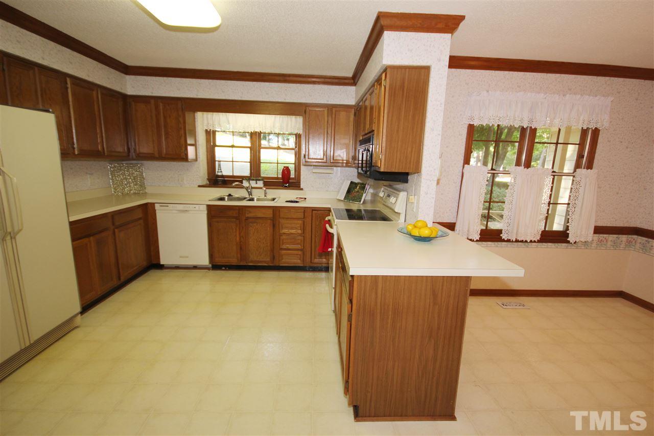 5305 Ridgeloch Place Raleigh, NC 27612 - Photo 7 of 23 a kitchen with a sink stove and refrigerator