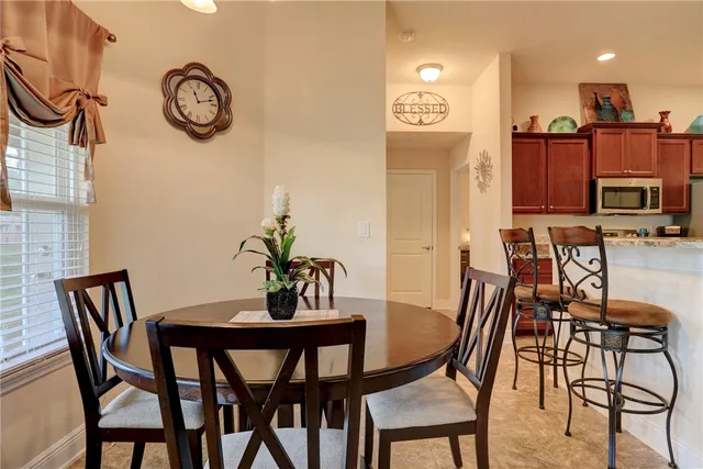 a view of a dining room with furniture and a chandelier