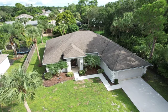 an aerial view of a house having yard patio and backyard
