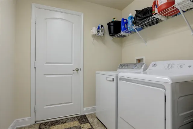 a view of storage and utility room with washer and dryer