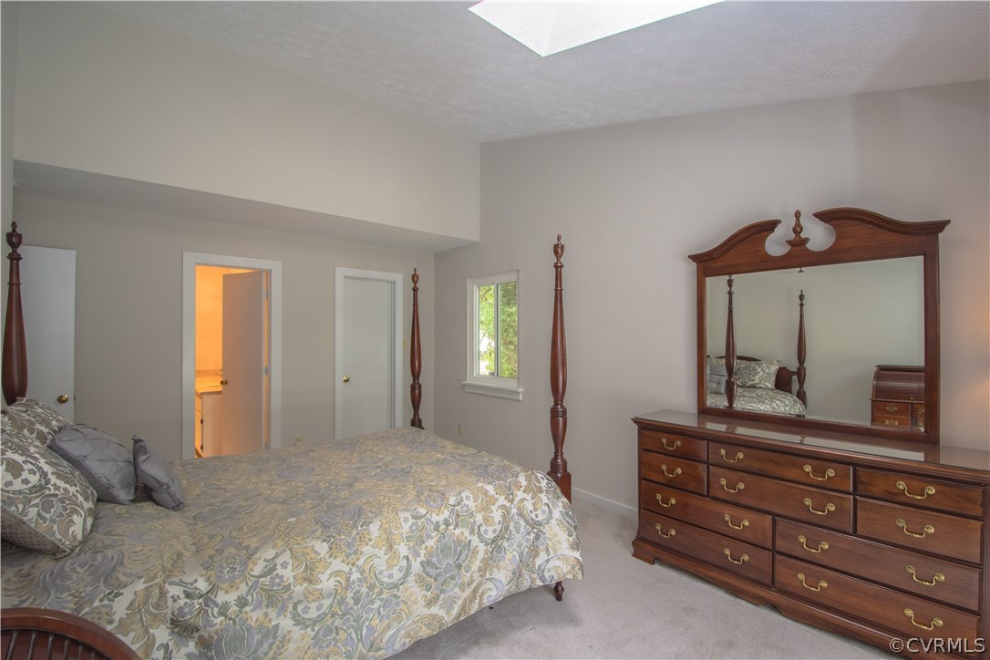 10634 Ramshorn Road Midlothian, VA 23113 - Photo 26 of 41 a bedroom with a bed and a dresser with mirror