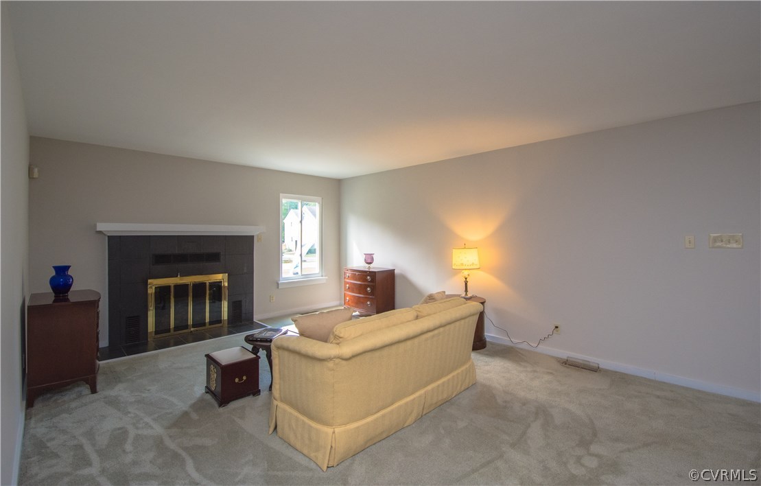 10634 Ramshorn Road Midlothian, VA 23113 - Photo 8 of 41 a living room with furniture and a fireplace