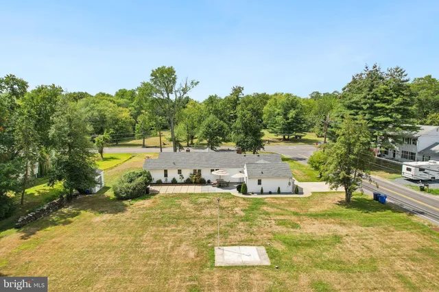 a view of a swimming pool with an ocean and trees in the background