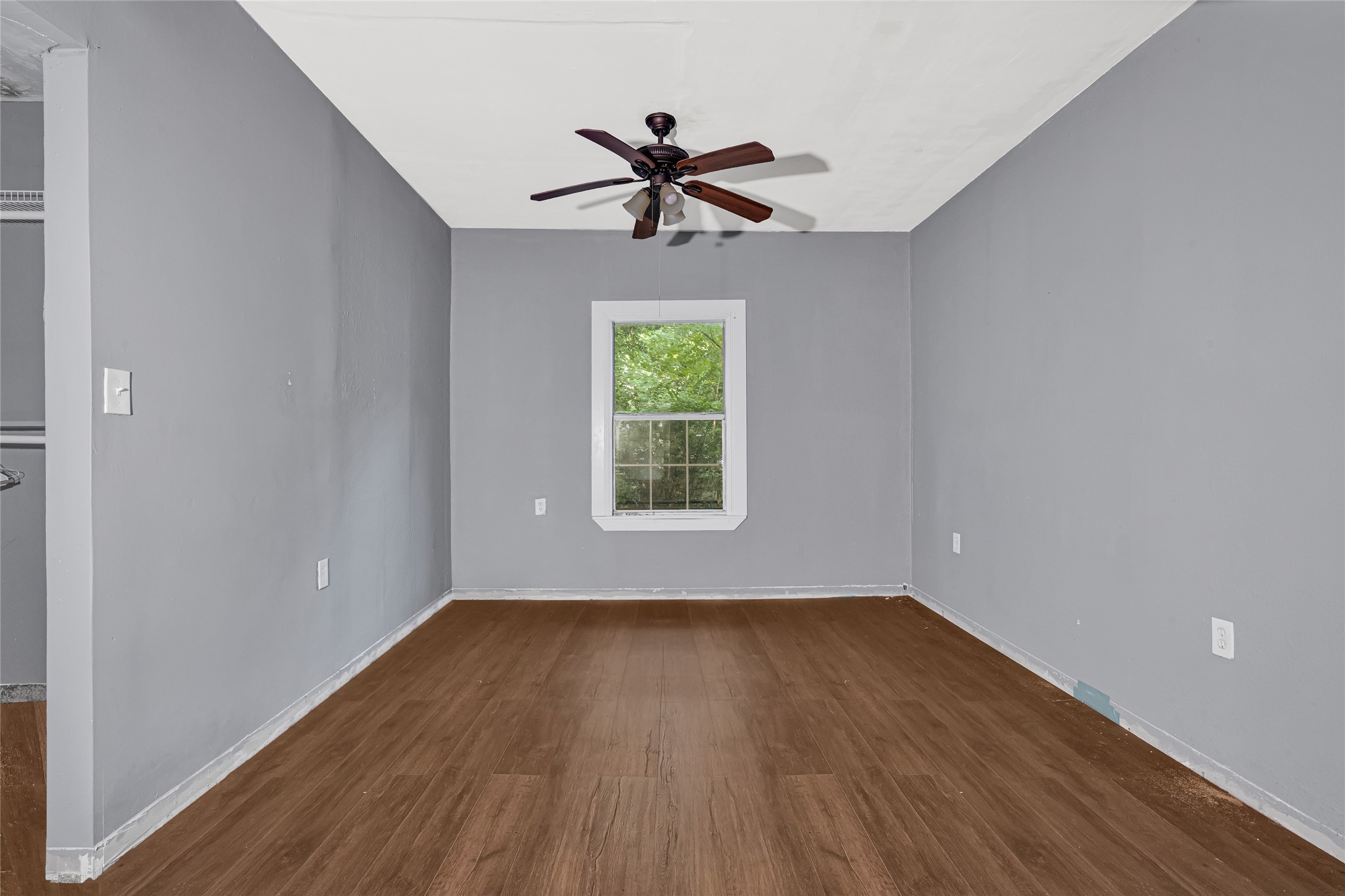 7305 Tremper Street Houston, TX 77020 - Photo 13 of 28 a view of empty room with wooden floor and fan