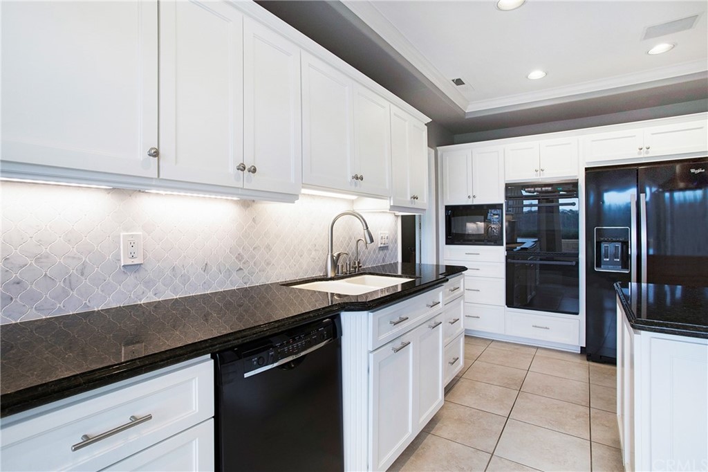 16 Bethany Laguna Niguel, CA 92677 - Photo 21 of 38 a kitchen with granite countertop a sink and cabinets